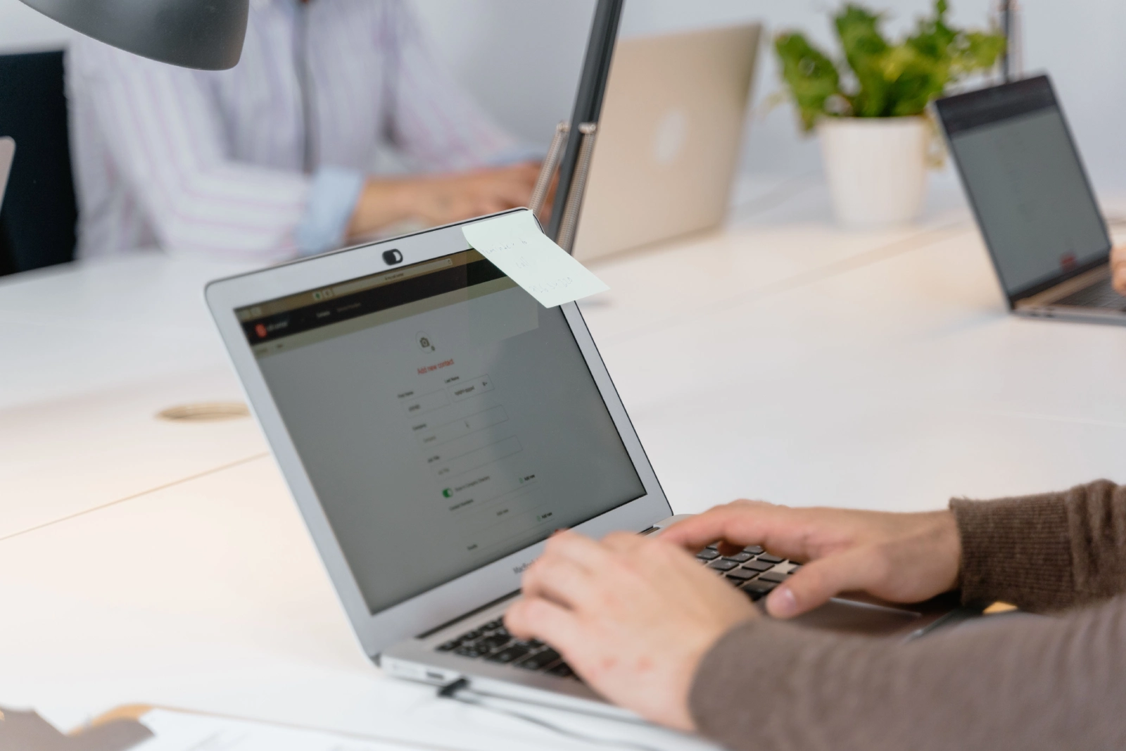 Person filling out a form on laptop during verification process